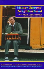 Mister Rogers sitting with trolley from his television show